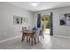 Dining room features a modern table set with grey chairs and access to backyard at 2960 Boating Blvd, Kissimmee, FL 34746