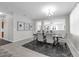 Open dining area with a dark wood table, neutral chairs, and view of adjacent living space at 2960 Boating Blvd, Kissimmee, FL 34746