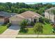 Charming single-story home with manicured lawn, mature trees, and attached two-car garage at 2960 Boating Blvd, Kissimmee, FL 34746