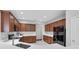 Kitchen featuring dark cabinets, sleek black appliances, and lots of counter space at 2960 Boating Blvd, Kissimmee, FL 34746