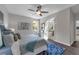 Bright main bedroom with ceiling fan, stylish decor and ensuite bath access at 2960 Boating Blvd, Kissimmee, FL 34746