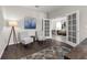 Modern office featuring wood-look floors, modern decor, a stylish lamp, and French doors leading to the living room at 2960 Boating Blvd, Kissimmee, FL 34746