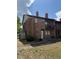 Brick condo features a quaint balcony, side shed, and an unfinished front yard at 5032 Downing St # 10, Orlando, FL 32839