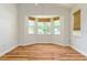 Bright bedroom with wood flooring, a bay window with blinds, and ample natural light at 777 Summit Greens Blvd, Clermont, FL 34711