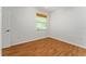 An empty bedroom featuring laminate flooring, a ceiling fan and natural light streaming through the window at 777 Summit Greens Blvd, Clermont, FL 34711