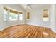 Spacious bedroom featuring wood flooring, a ceiling fan, and large windows with woven blinds at 777 Summit Greens Blvd, Clermont, FL 34711