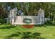 Summit Greens community entrance, featuring a well-manicured landscape and a welcoming stone sign at 777 Summit Greens Blvd, Clermont, FL 34711