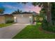 Charming home boasts a brick driveway, attached garage, and inviting curb appeal with mature landscaping at 777 Summit Greens Blvd, Clermont, FL 34711