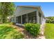 A covered and screened patio adds extra living space to this beautiful property with mature landscaping at 777 Summit Greens Blvd, Clermont, FL 34711