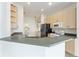 The well-lit kitchen features modern appliances, sleek countertops, and ample cabinet storage at 777 Summit Greens Blvd, Clermont, FL 34711