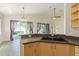 Open kitchen area with a large sink, countertop, and view of the adjacent living space at 777 Summit Greens Blvd, Clermont, FL 34711