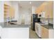 Bright kitchen with stainless steel appliances, ample counter space, and light wood cabinets at 777 Summit Greens Blvd, Clermont, FL 34711