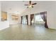 Spacious living room with vaulted ceilings, sliding glass doors to the lanai, and neutral tile floors at 777 Summit Greens Blvd, Clermont, FL 34711