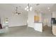 Bright, open living area with neutral tile floors, an open concept to the kitchen, and recessed lighting at 777 Summit Greens Blvd, Clermont, FL 34711