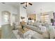 Bright and open living room with tile floors, neutral furniture, and vaulted ceilings offers a cozy atmosphere at 777 Summit Greens Blvd, Clermont, FL 34711