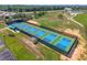 Aerial shot of pickleball courts with fencing, shade structures, and a parking lot at 777 Summit Greens Blvd, Clermont, FL 34711