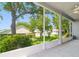 Screened porch with views of the landscaped backyard and mature trees at 777 Summit Greens Blvd, Clermont, FL 34711