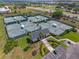 An aerial view of tennis courts with a clubhouse and parking at 777 Summit Greens Blvd, Clermont, FL 34711