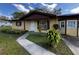Inviting front yard view with a walkway leading to the entrance of a cozy single-story home at 15 Monroe Ave, Debary, FL 32713
