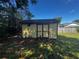 Outdoor shed with double doors, providing extra storage space in the backyard at 15 Monroe Ave, Debary, FL 32713