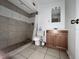 Bathroom featuring a tiled shower, toilet, vanity, and small mirror at 1925 Laredo Dr, Deltona, FL 32738