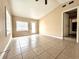 Spacious living room featuring tile floors, a window and a glass patio door to the backyard at 1925 Laredo Dr, Deltona, FL 32738