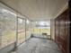 Screened-in patio with door to the interior and a sunny view to the backyard at 1925 Laredo Dr, Deltona, FL 32738