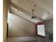 Living room featuring stone fireplace, tile floors, high ceilings with beams and a ceiling fan at 116 Wild Holly Ln, Longwood, FL 32779