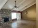 Living room with stone fireplace, tile floors, beams, and a ceiling fan at 116 Wild Holly Ln, Longwood, FL 32779