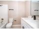 Bathroom featuring tub, toilet and single vanity with white cabinets, black hardware, and modern fixtures at 1839 Cranberry Isles Way, Apopka, FL 32712