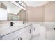 Bright bathroom featuring double vanity with white cabinets, black hardware, and modern fixtures at 1839 Cranberry Isles Way, Apopka, FL 32712