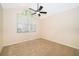 Neutral bedroom with a ceiling fan, carpet flooring, and a window at 1839 Cranberry Isles Way, Apopka, FL 32712