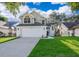 Charming two-story home showcasing a well-manicured lawn and an attached two-car garage at 1839 Cranberry Isles Way, Apopka, FL 32712