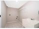 Functional laundry room with tile flooring, a utility sink and shelf at 1839 Cranberry Isles Way, Apopka, FL 32712