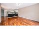 Open-concept living room flows into modern kitchen, with hardwood floors at 1839 Cranberry Isles Way, Apopka, FL 32712