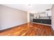 Bright living room area with hardwood floors, open to the modern kitchen at 1839 Cranberry Isles Way, Apopka, FL 32712