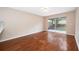 Inviting living space with polished hardwood floors and a sliding glass door at 1839 Cranberry Isles Way, Apopka, FL 32712