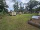 Expansive backyard featuring mature trees and a playground, providing ample space for outdoor activities at 3509 Lisa Ln, Lakeland, FL 33801