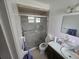 Bathroom featuring a glass-enclosed shower, and a dark vanity with a white sink at 3509 Lisa Ln, Lakeland, FL 33801