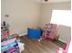 Bright bedroom featuring vinyl flooring, playful decor, and ample natural light from the window at 3509 Lisa Ln, Lakeland, FL 33801