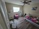 Bedroom with laminate flooring and natural light from a window at 3509 Lisa Ln, Lakeland, FL 33801