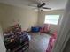 Bedroom featuring vinyl flooring, playful decor, and ample natural light from the window at 3509 Lisa Ln, Lakeland, FL 33801