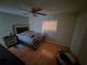 Bedroom featuring hardwood flooring, neutral walls, and a comfortable bed with stylish headboard at 3509 Lisa Ln, Lakeland, FL 33801