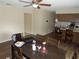Open concept dining room with ceiling fan, adjacent to the kitchen with laminate flooring at 3509 Lisa Ln, Lakeland, FL 33801