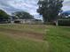 A home exterior showcasing a well-manicured lawn and carport with a long driveway at 3509 Lisa Ln, Lakeland, FL 33801