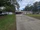 A charming home with a carport, featuring a spacious driveway and a well-maintained lawn at 3509 Lisa Ln, Lakeland, FL 33801