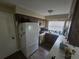 Kitchen features wood cabinets, white appliances, laminate flooring and a window for natural light at 3509 Lisa Ln, Lakeland, FL 33801