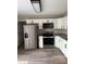 Well-lit kitchen featuring stainless steel appliances, granite countertops and modern white cabinetry at 5356 Spivey Glen Ct, Lakeland, FL 33810