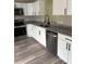 Modern kitchen showcasing granite countertops, stainless steel appliances, and sleek black hardware at 5356 Spivey Glen Ct, Lakeland, FL 33810