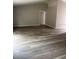 Living Room showcasing new wood flooring and a neutral color scheme at 5356 Spivey Glen Ct, Lakeland, FL 33810